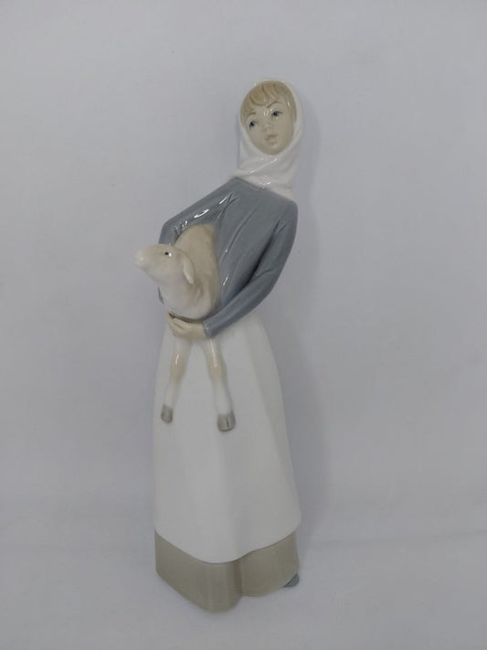 Statue of a girl holding a lamb #4584, Lladro